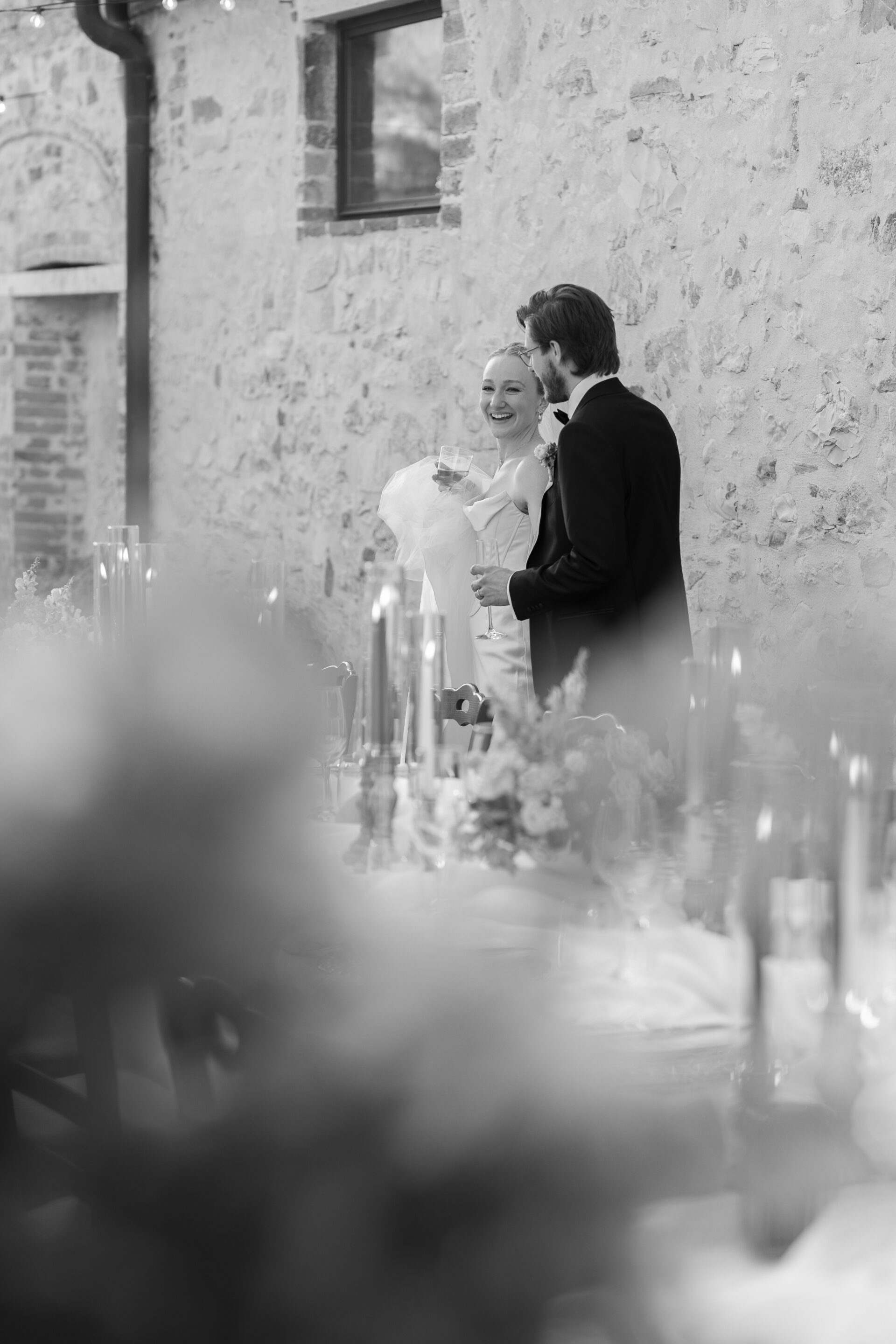 The bride and groom look at their tablescape for their luxury Italian wedding