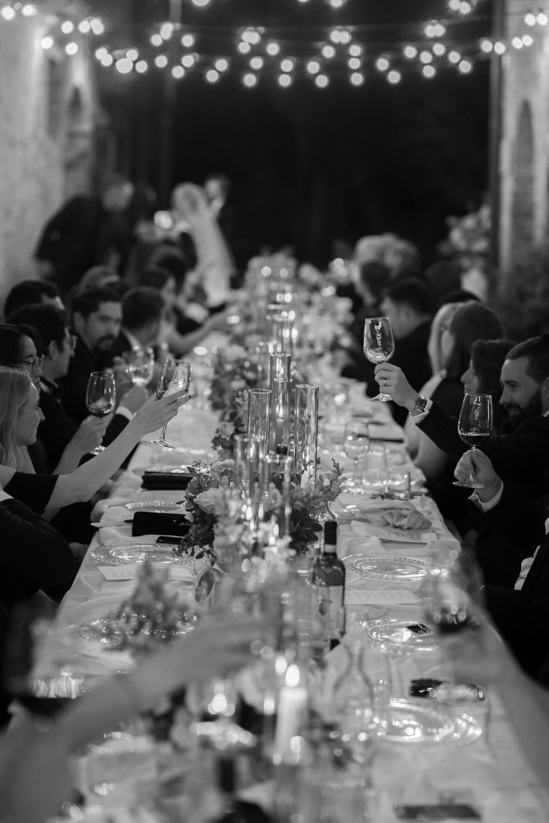 Guests enjoy an Italian wedding feast at luxury Tuscan wedding