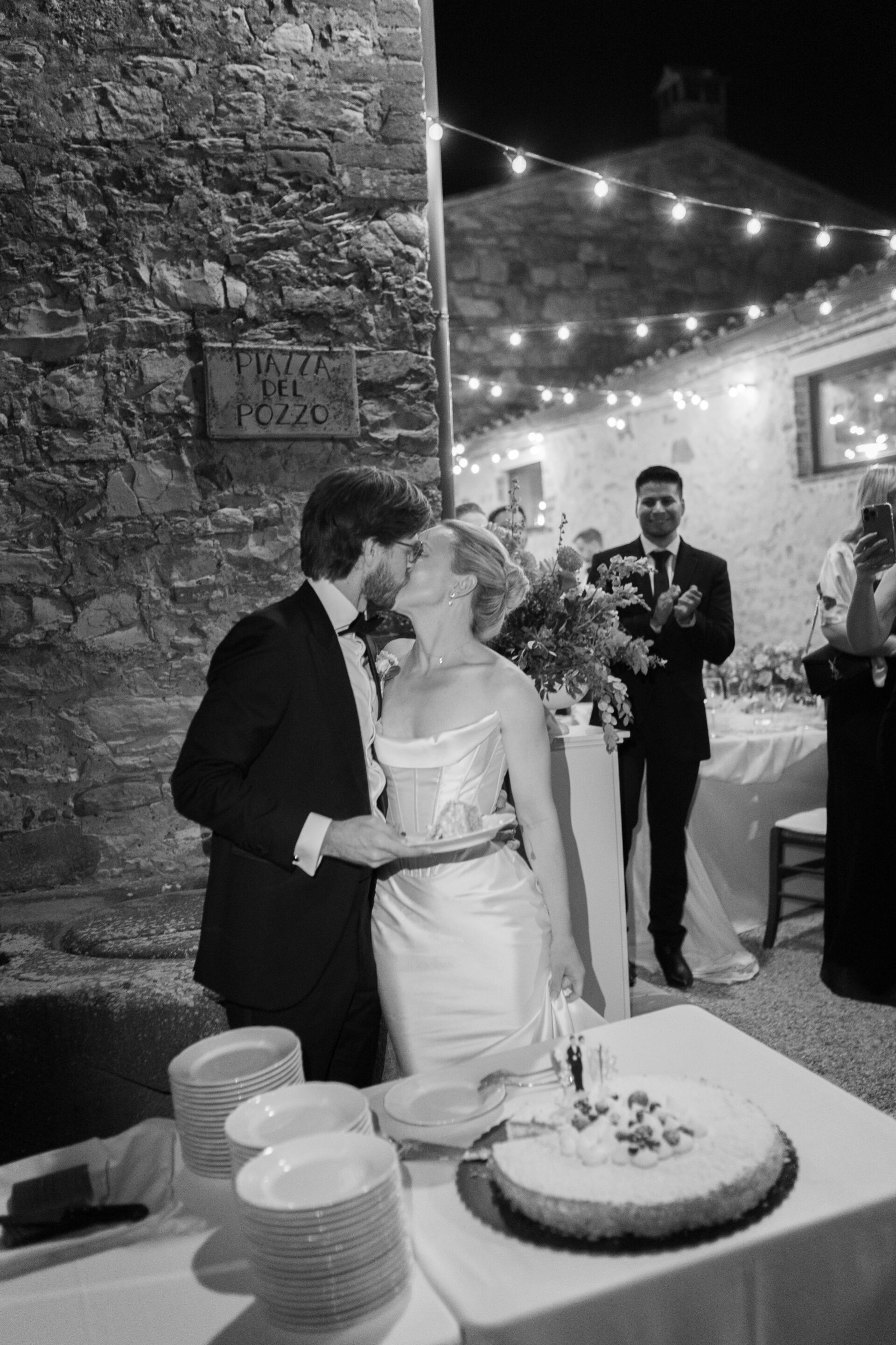 The bride and groom cut the cake at their luxury Tuscan wedding
