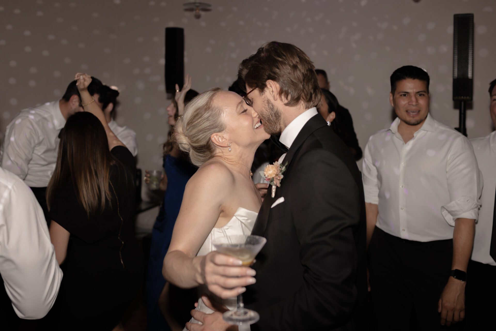 The bride and groom share a kiss at their luxury Italian wedding afterparty