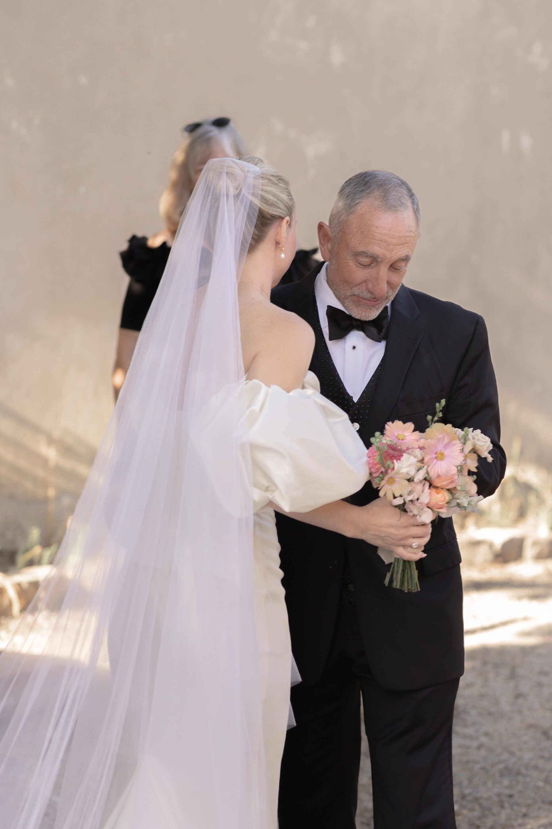 The bride shares an embrace with her father at her Italian wedding