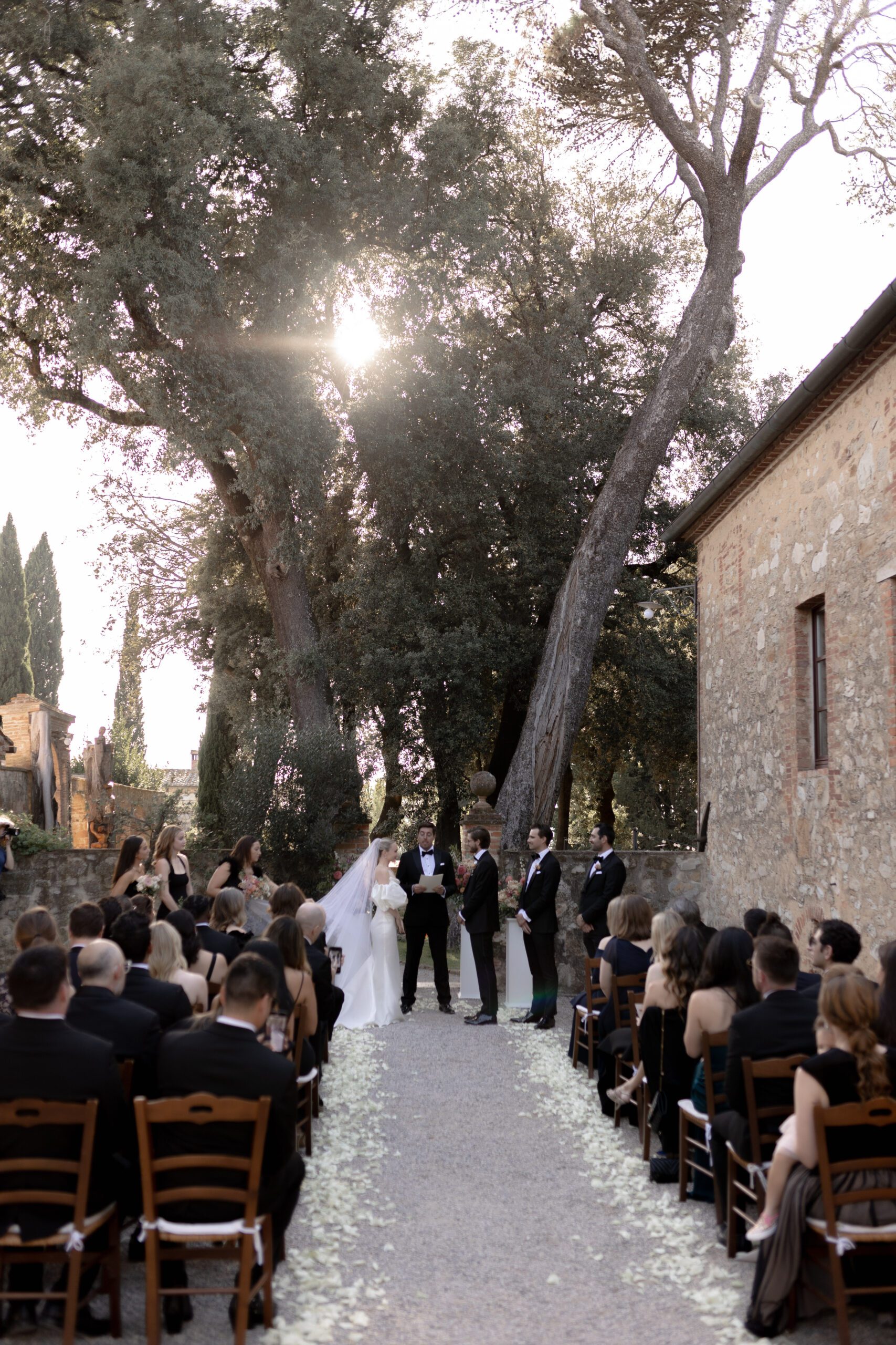 The bride and groom exchange vows in their Tuscan wedding ceremony