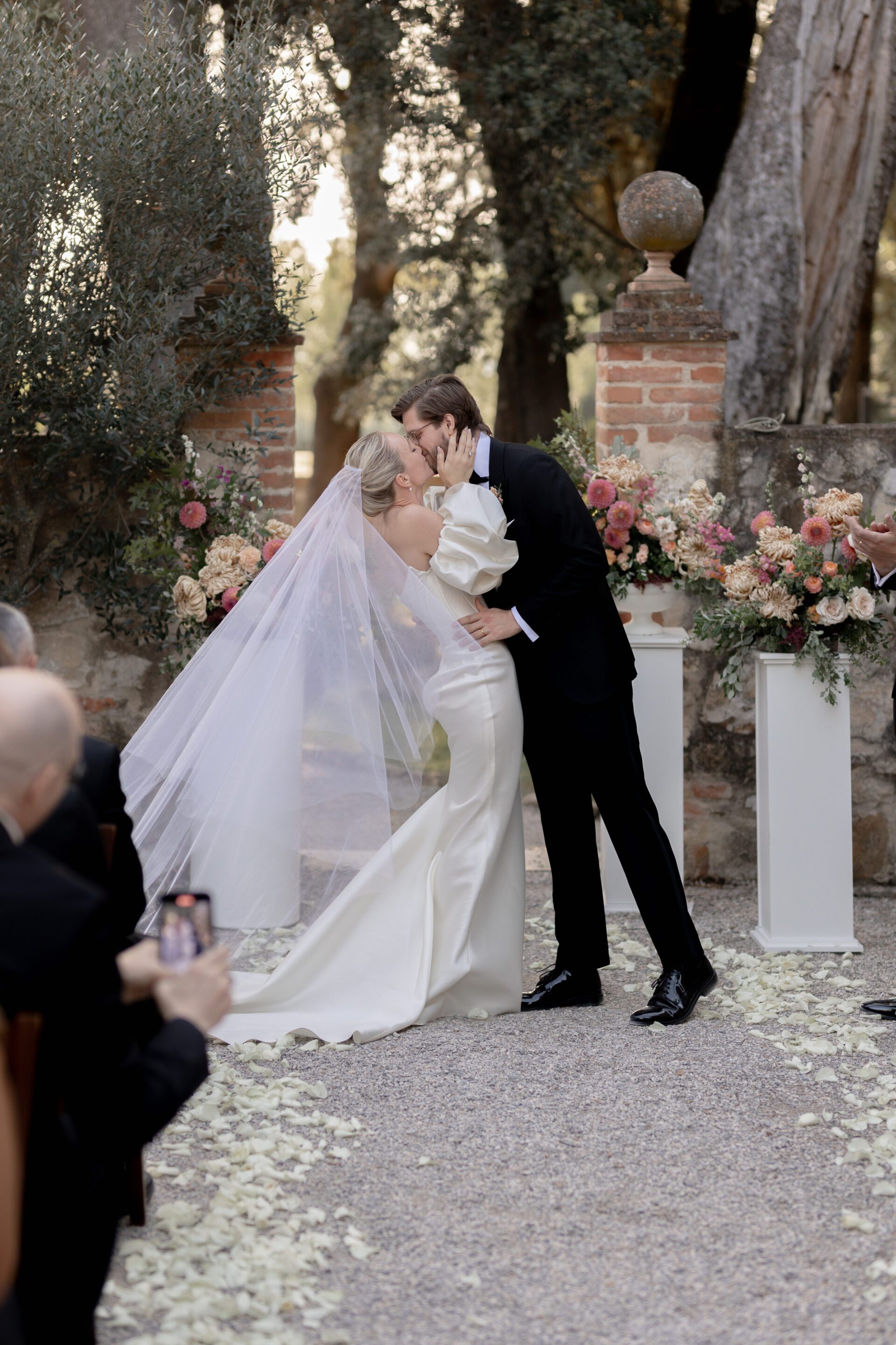The bride and groom kiss during their Italian wedding ceremony