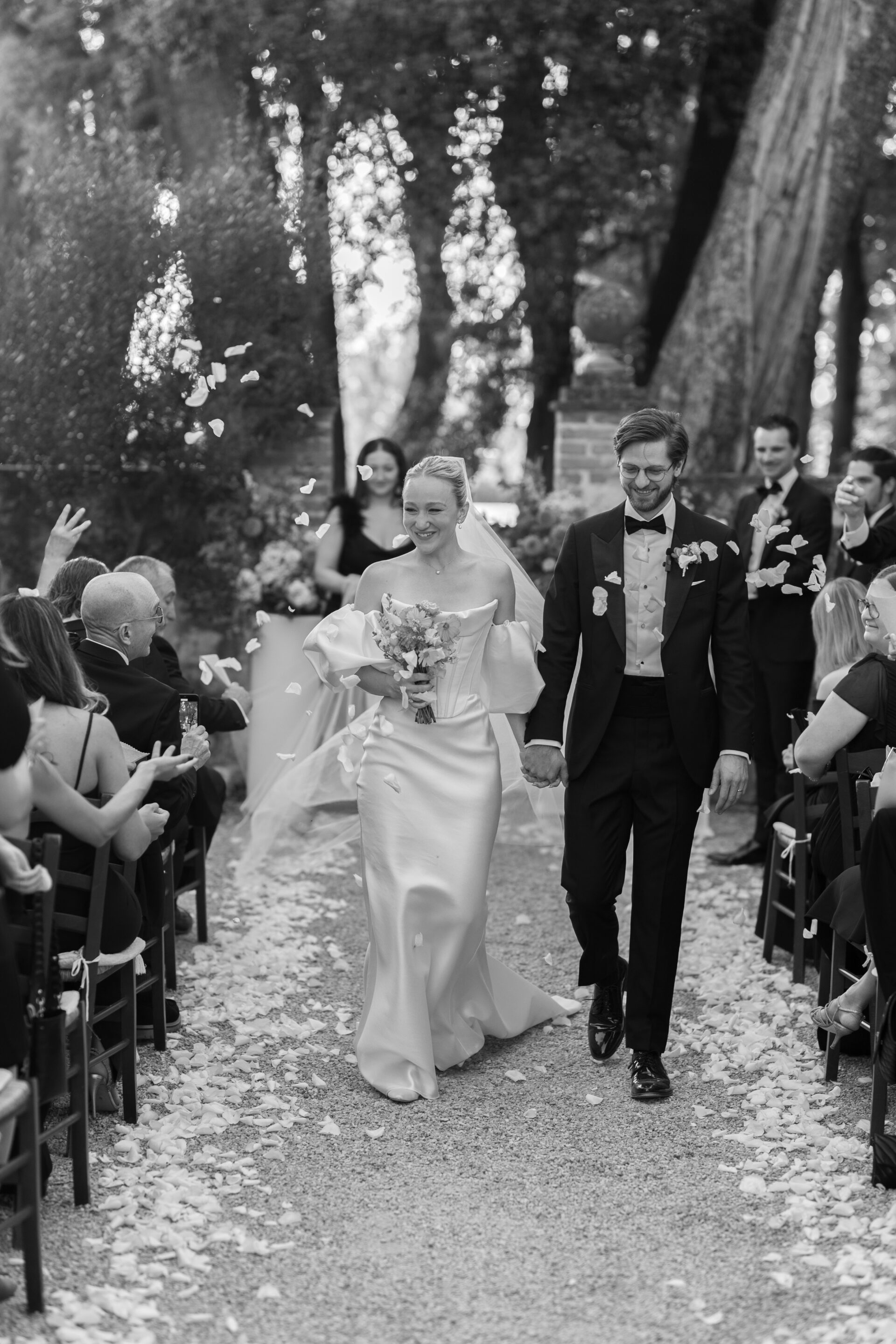 Italian wedding photography captures confetti tunnel at luxury Italian wedding ceremony
