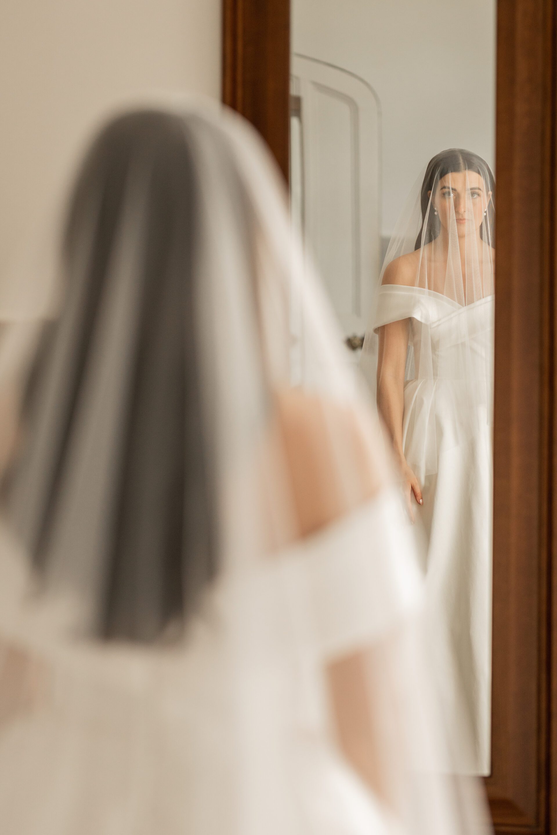 The bride surveys her reflection during bridal prep at Tortworth Court