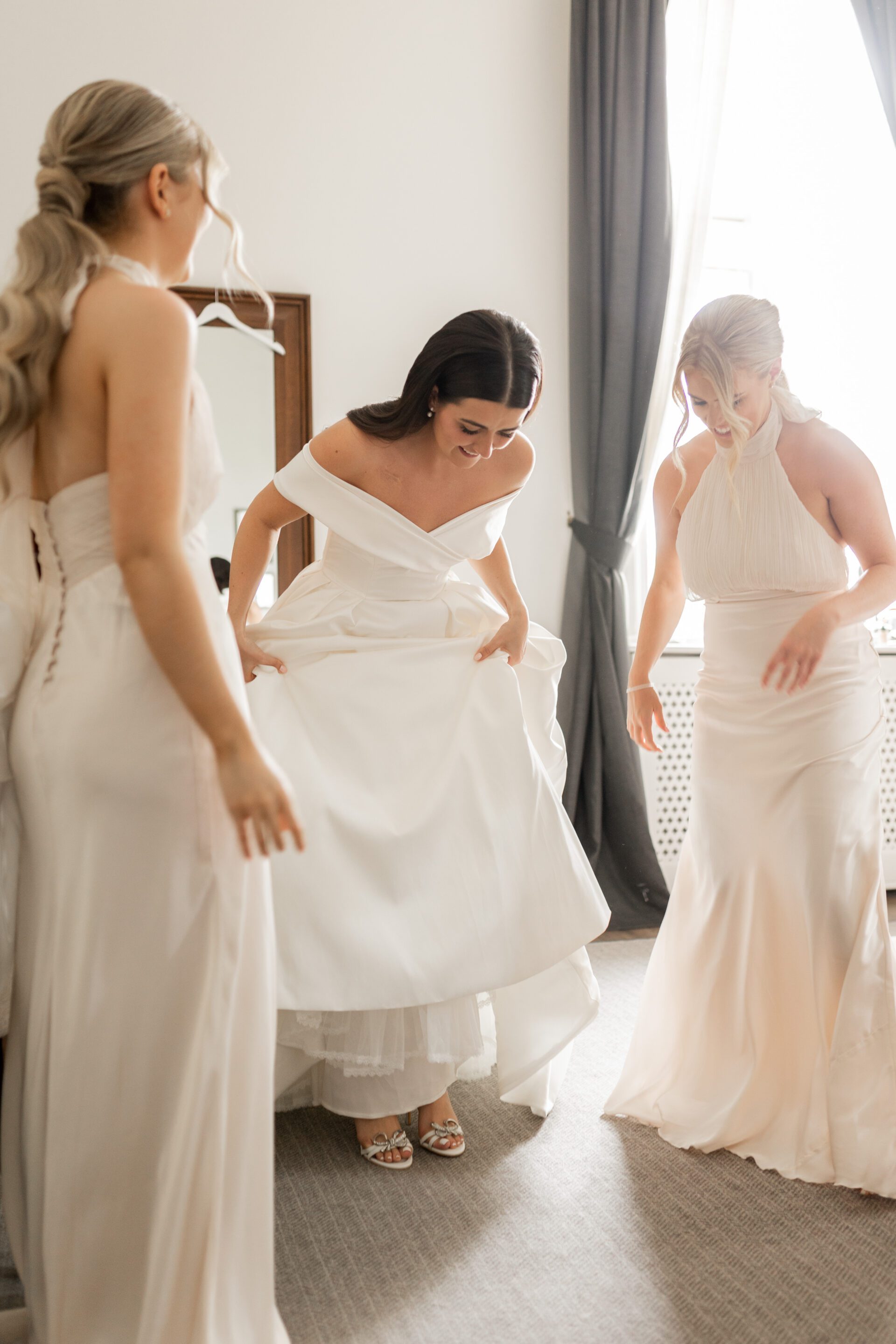 The bridal party help the bride get ready for her wedding at Tortworth Court