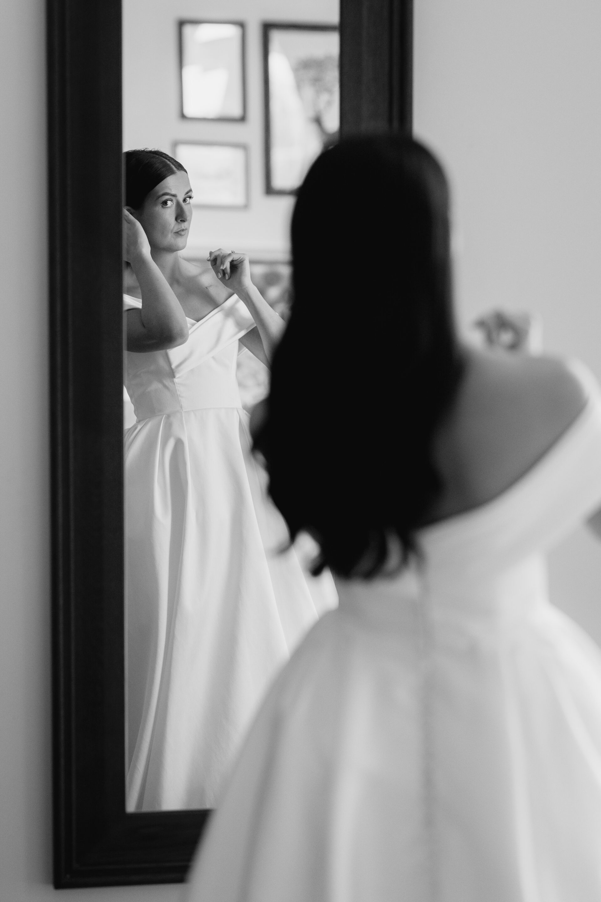 The bride surveys her reflection during bridal prep at Tortworth Court