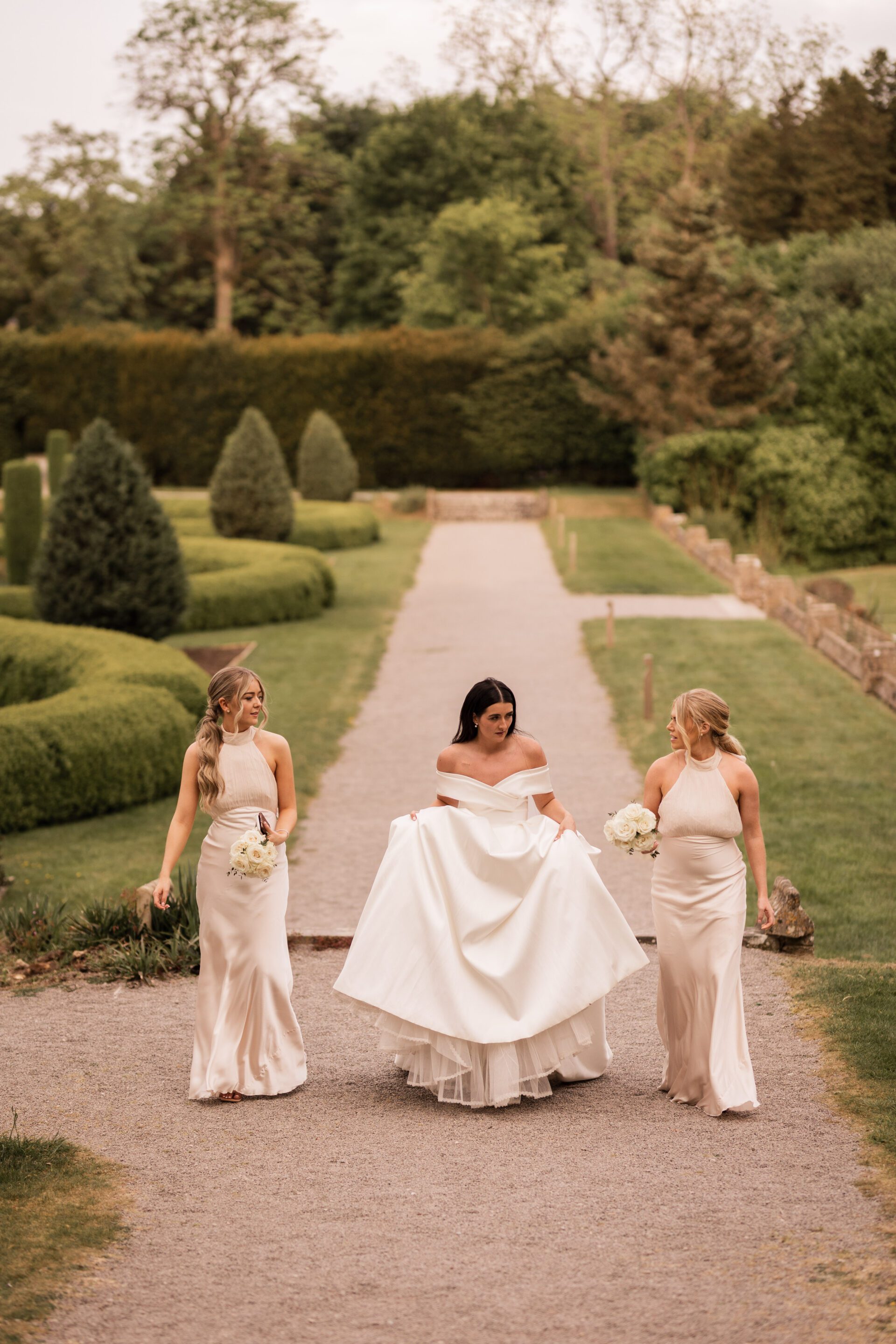The bride walks with her bridesmaids at Tortworth Court