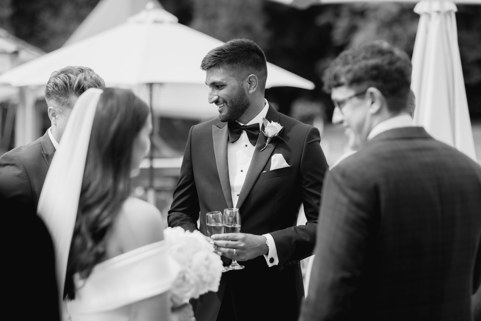 The groom talks with wedding guests at Tortworth Court