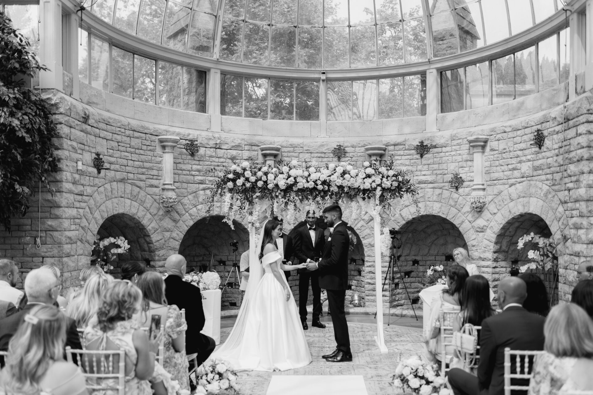 The bride and groom exchange vows during the wedding ceremony in the Orangery at Tortworth Court