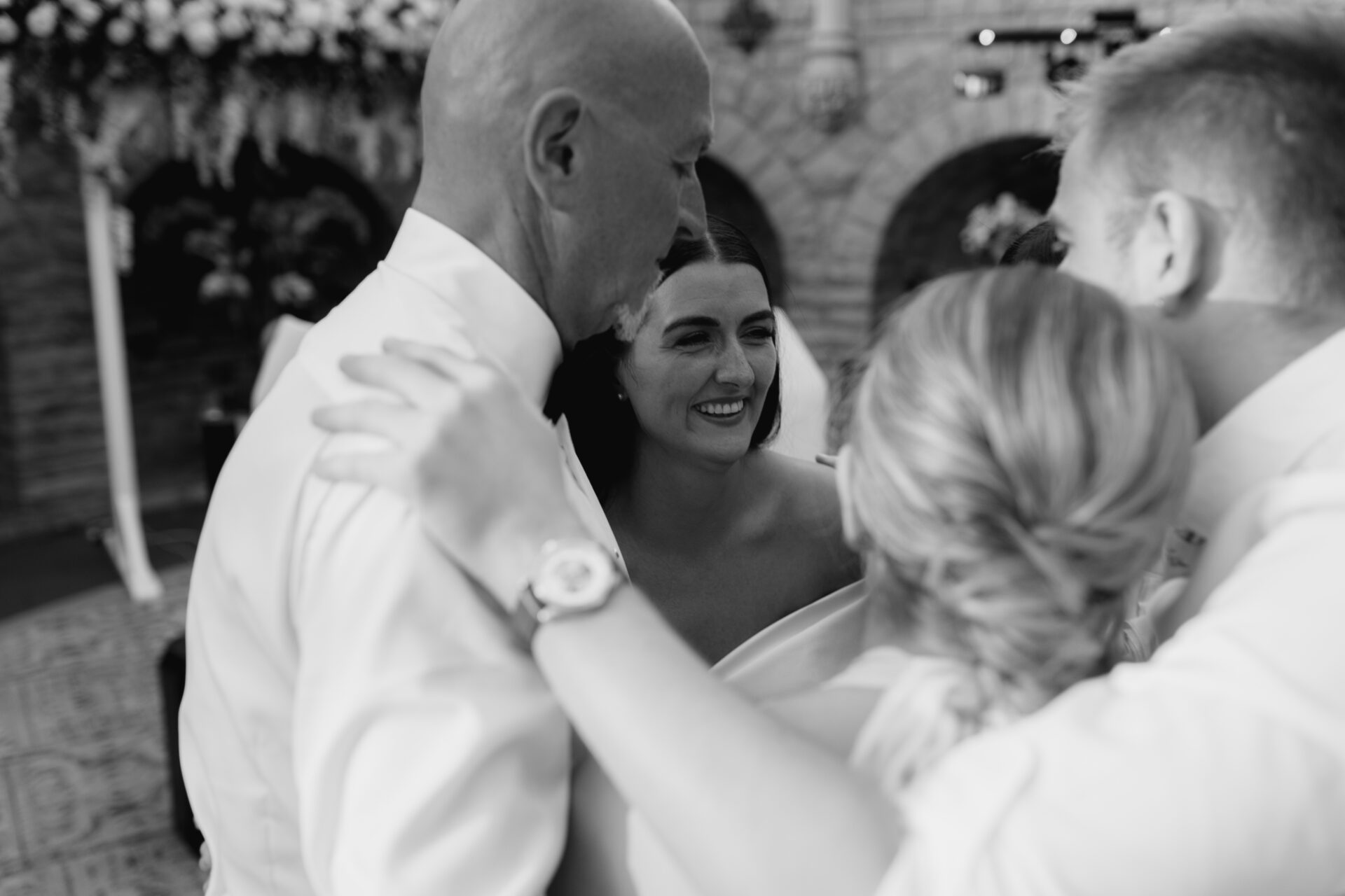 The bride embraces her family in the Orangery at Tortworth Court